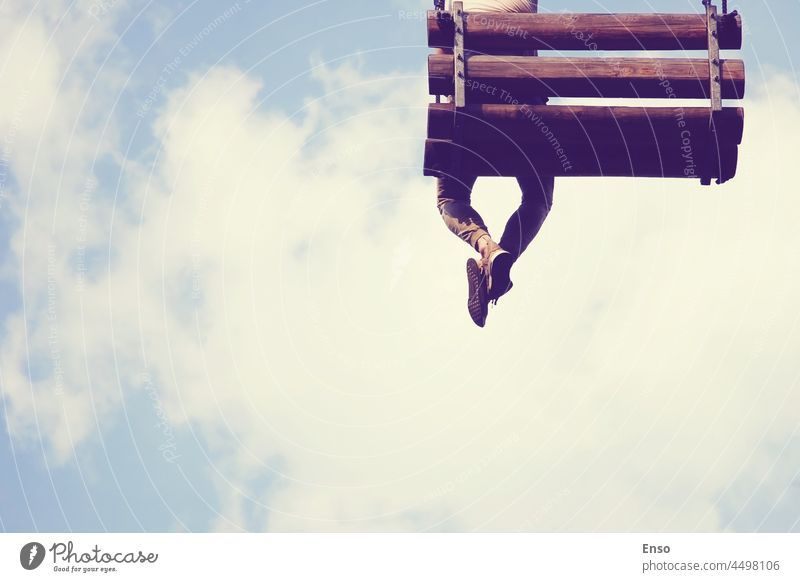 Dreamer in the skies dangling legs air bench dream enjoy heaven man romantic alone sitting sky summer dangle feet swing legs dangle legs atmospheric