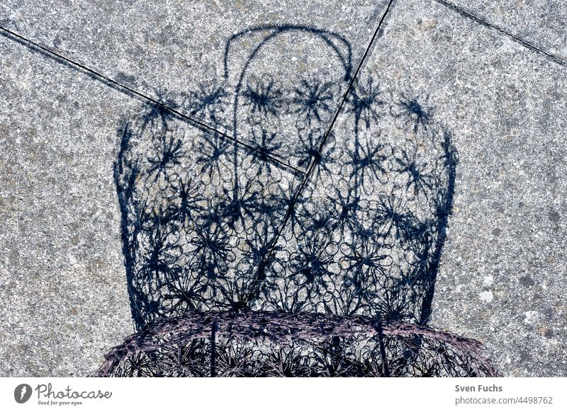 Shadow of a shopping basket on concrete slabs Bag Concrete Wire pretence Wire basket Basket vintage Rust Old Pattern Delicate Shopping Fashion Consumption Empty