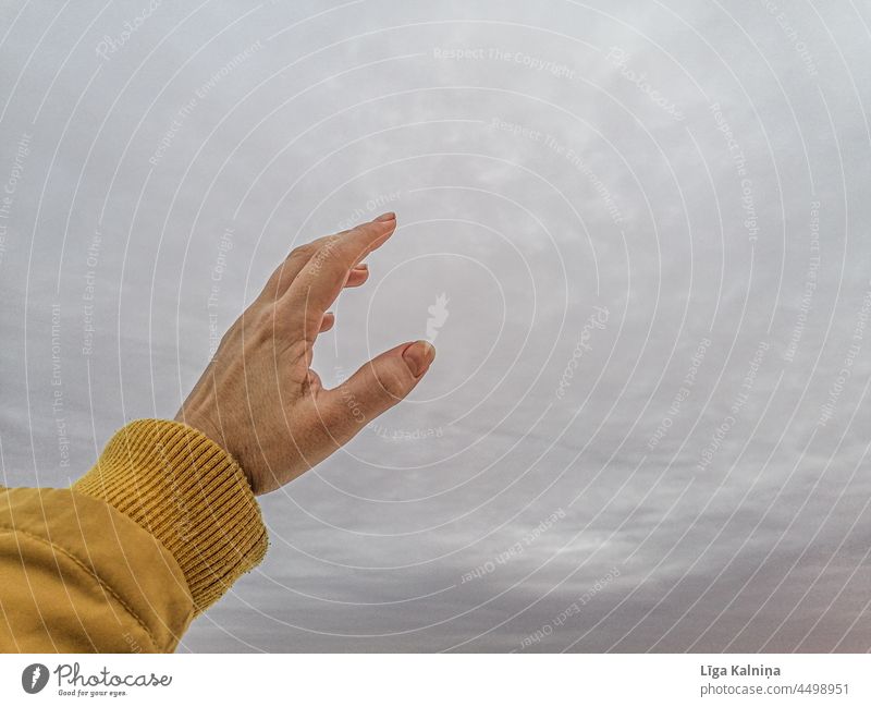 finger pointing to grey sky young female woman people lifestyle person adult outdoors nature Cold Sky Skyline Yellow Fingers Reach reaching minimal Minimalistic