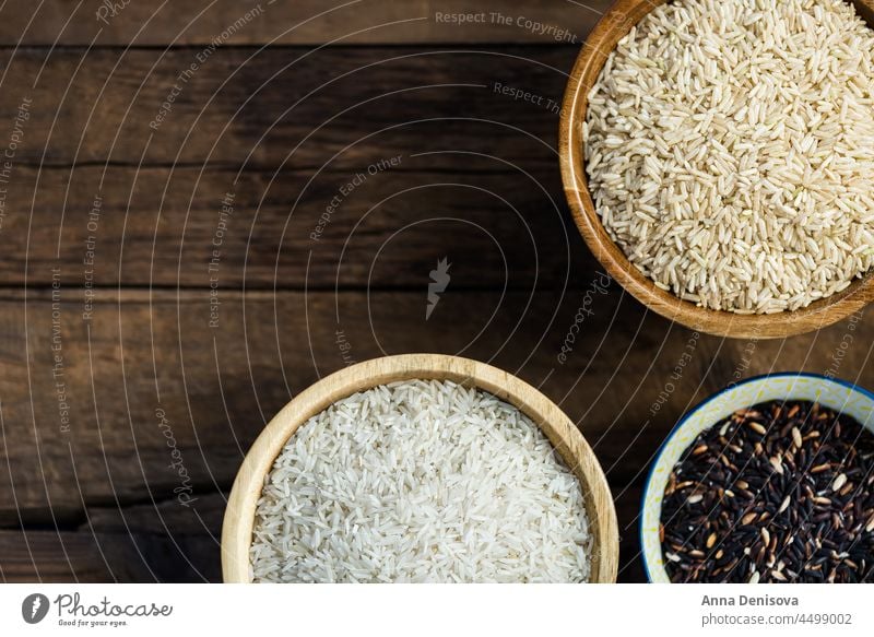 Different types of rice in wooden bowls such as basmati, brown a different white table various cereals black thai food healthy wild ingredient grain mix closeup