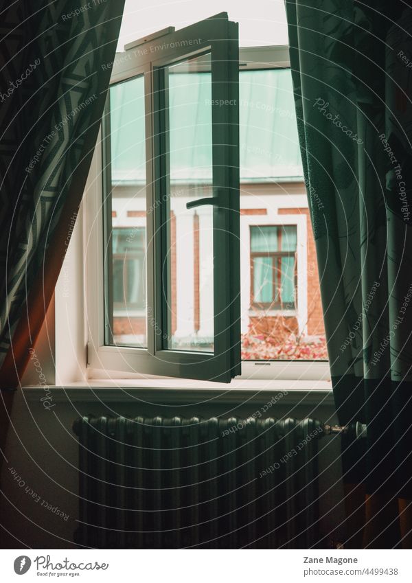 Vintage radiator and open window with look outside, moody autumn scene heating central heating autumn mood look through window curtains autumn outside cosy