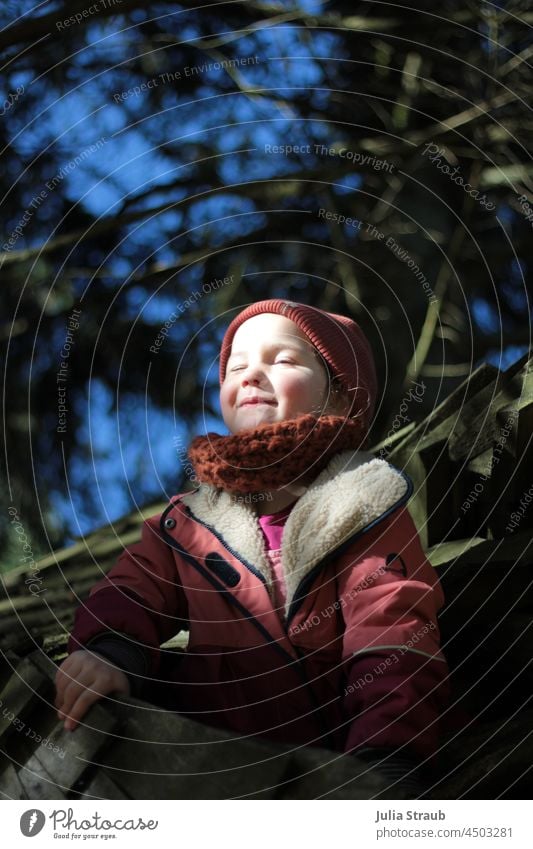 Girl enjoys the sun on the nature playground Toddler Child Infancy Playing Experiencing nature natural playground Playground wooden shingles trees Tree house