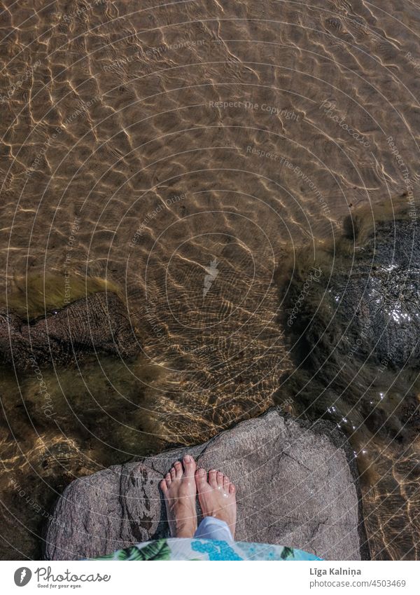 view from above of bare feet on stone next to water at sea Ocean Baltic Sea Vacation & Travel Baltic coast Beach chair vacation Sky Tourism Relaxation Coast