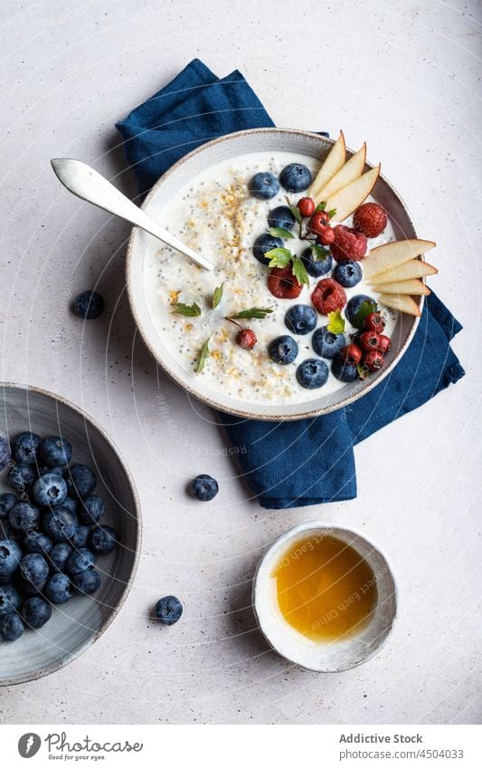 Porridge with berries on table porridge berry topping breakfast healthy food morning serve vitamin oatmeal blueberry raspberry fresh pear bowl organic portion