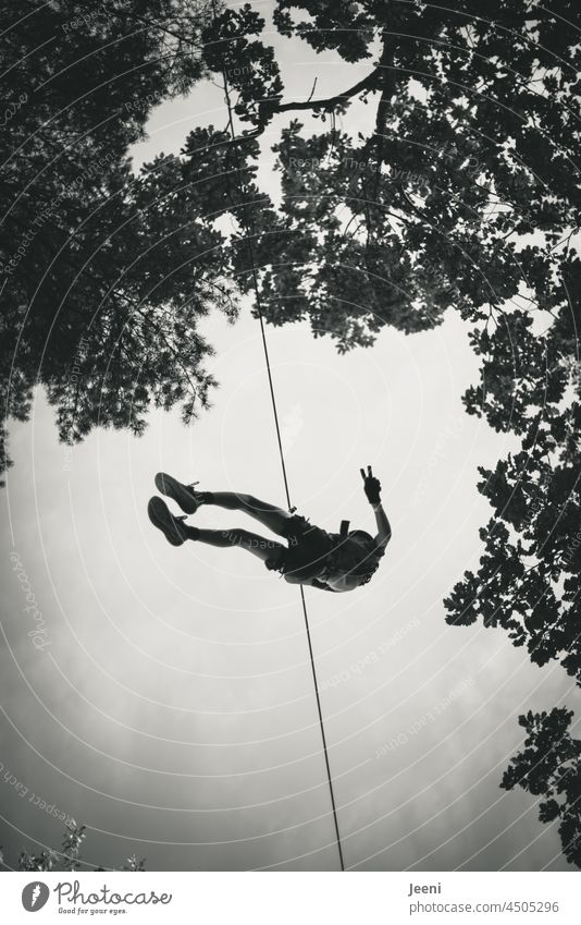 Outdoor cable car ride Cable car Rope swift Speed Joy Wire cable steel cable Downward Hang Tall down Worm's-eye view Child Body Posture peace Show of hands