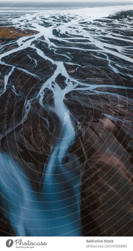 Amazing aerial landscape of rivers flowing through mountainous valley nature picturesque terrain wild highland stream breathtaking scenic iceland rocky peak