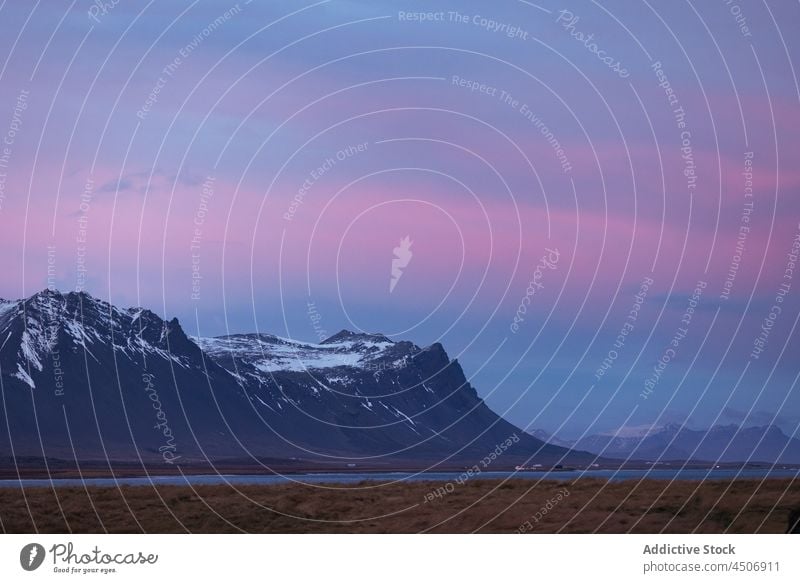 Picturesque sunset sky over snowy mountain ridge landscape nature sea scenic valley range highland ocean sundown iceland amazing picturesque scenery rocky slope
