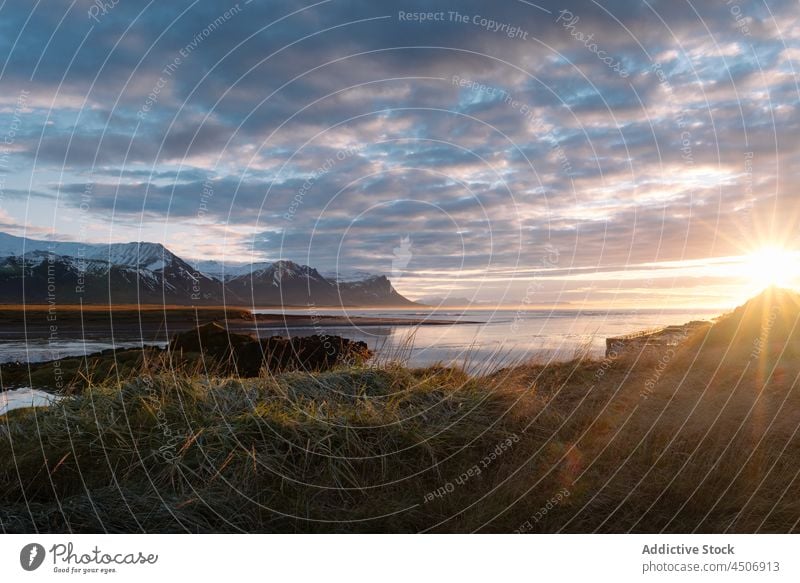 Scenic sunset over sea and snowy mountains nature landscape sky picturesque lake calm scenic peaceful highland iceland range sundown tranquil environment