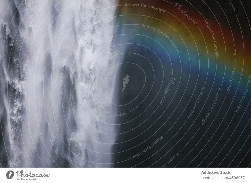 Powerful waterfall and rainbow in rocky gorge nature cliff cascade power splash stream scenery energy scenic rapid ravine breathtaking spectacular skogafoss