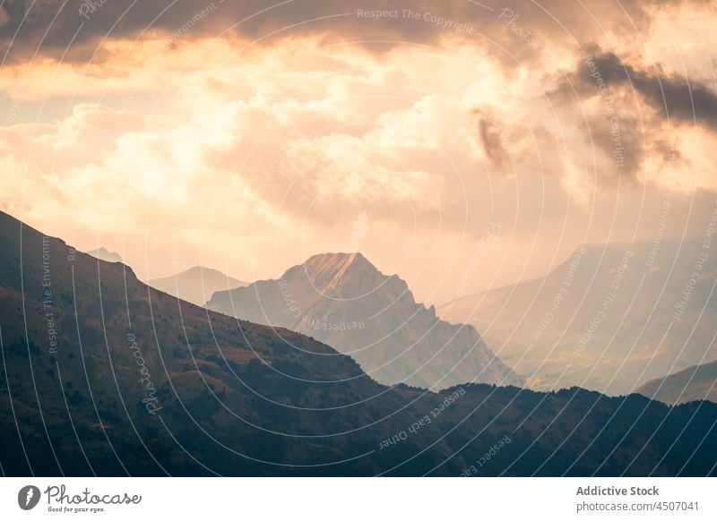 Mountainous area against cloudy sky mountain rock cliff highland range nature ridge slope height pyrenees spain rough formation environment scenery peak rocky