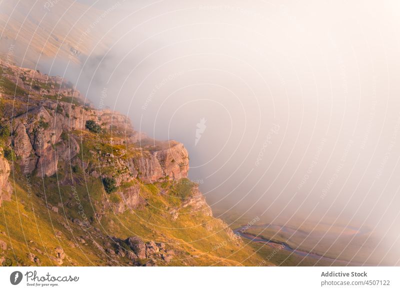 Rocky slope covered with fog mountain cliff mist rock nature stone steep landscape pyrenees spain haze overcast thick rough formation environment scenery rocky