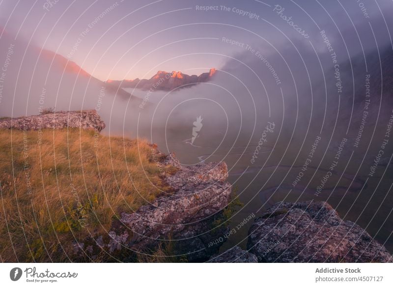 Mountainous terrain with fog at sunrise mountain mist adventure nature journey hiker travel pyrenees spain environment scenery landscape wild location natural