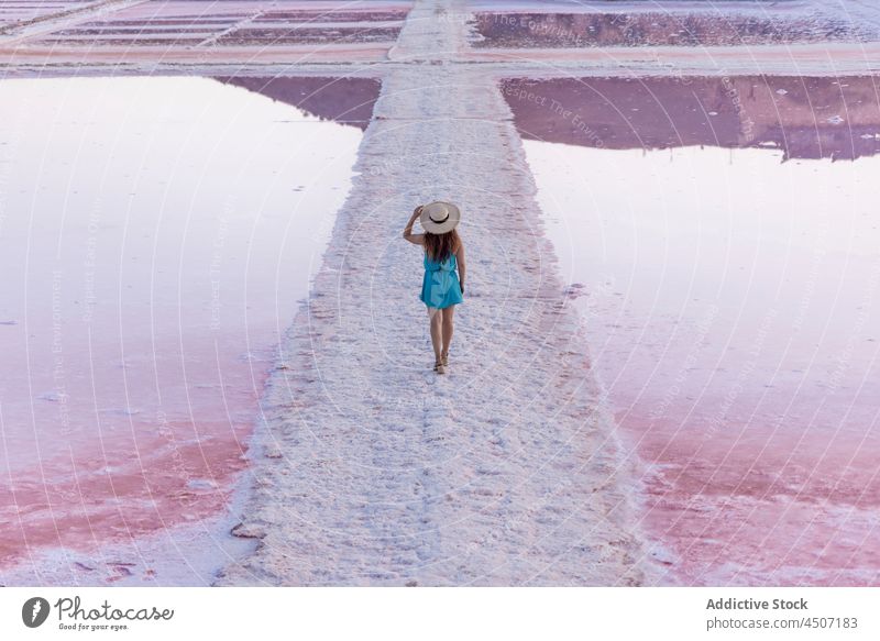 Woman standing in salty lake with pink water woman geology lagoon clear freedom ferment mineral female reservoir basin formation scenery peace rough crystal