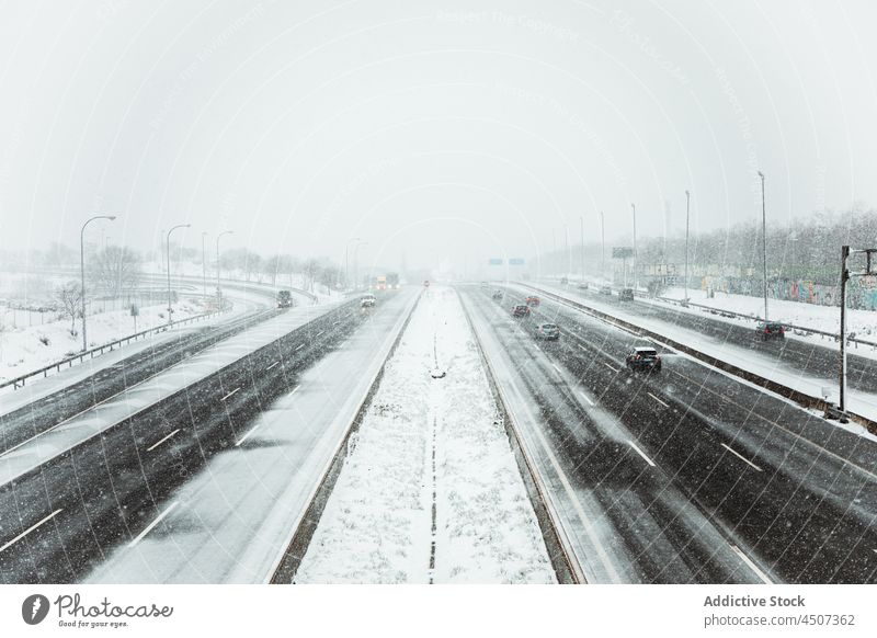 Car driving on asphalt road during snowfall car drive winter transport haze fog traffic gloomy motion cold roadway frost auto wintertime vehicle overcast spain