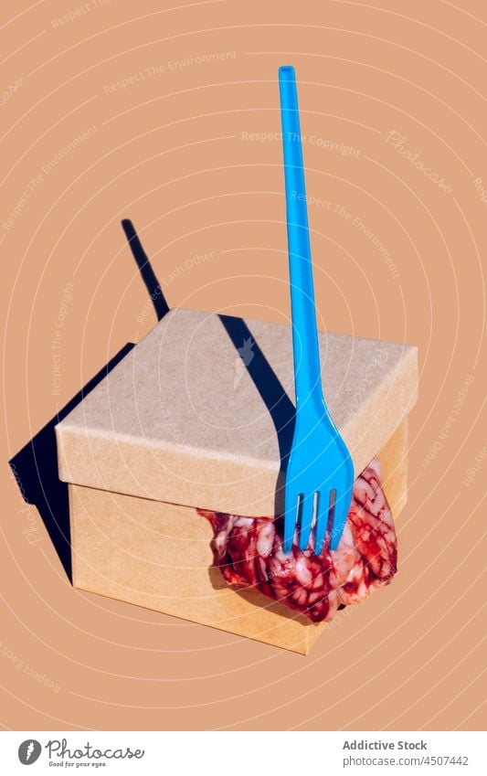 Brains coming out of carton box brain nourishment organ raw food unusual concept cardboard container deliver plastic organic odd creative fork vivid style