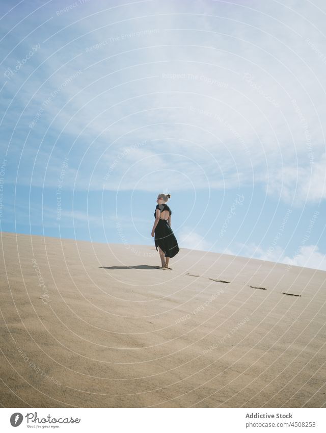 Woman in dress walking on sandy dunes woman desert arid hot harmony elegant exotic freedom female serene environment barefoot hill explore heat sunlight drought