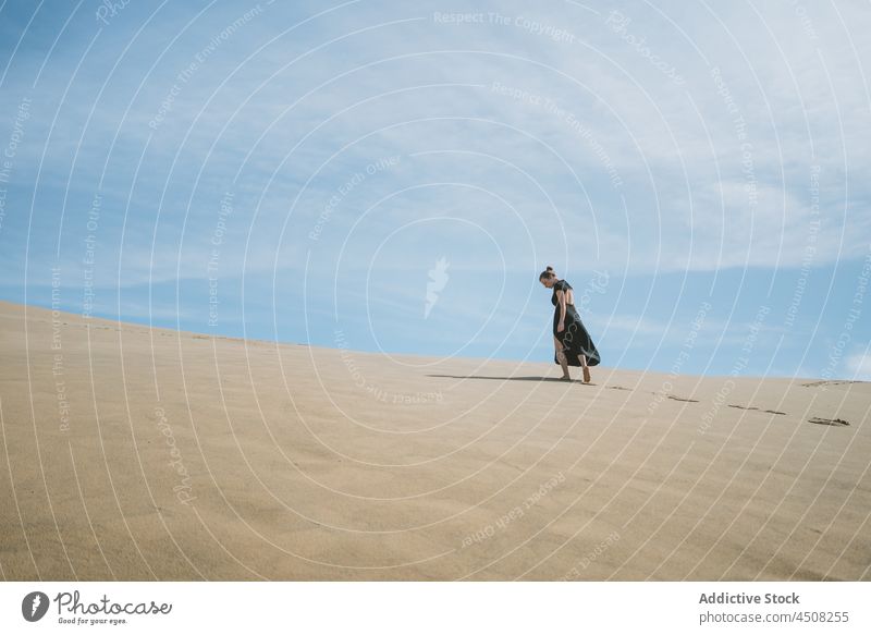 Woman in dress walking on sandy dunes woman desert arid hot harmony elegant exotic freedom female serene environment barefoot hill explore heat sunlight drought