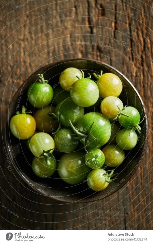 Bowl with unripe cherry tomatoes harvest farm bowl cultivate agriculture vegetable food whole season healthy vitamin many agronomy countryside farmland collect