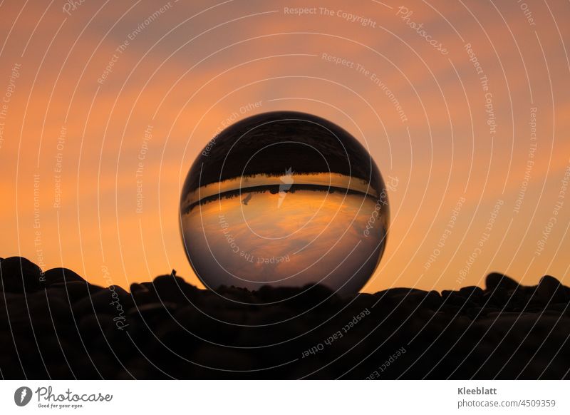 Glass globe photography - Golden light - Sunset - Cloud reflection crystal ball image Glass ball photography golden hour cloud reflection Exterior shot