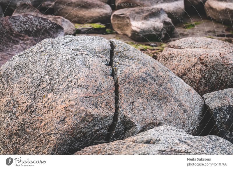 huge large big naturally splitted boulder in Baltic sea beach abstract ancient baltic baltic sea coast bay blue boulders cape closeup coastline construction