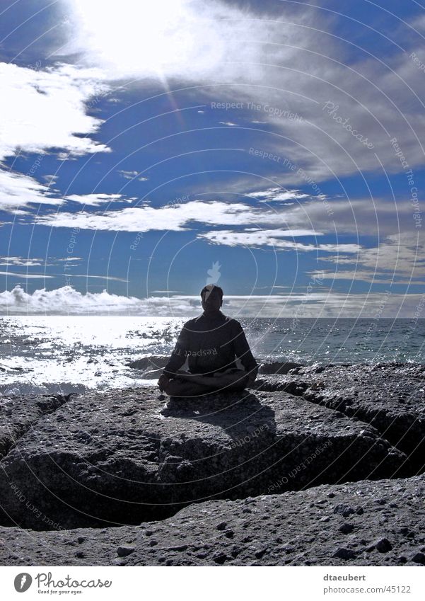 Meditation on the rock Ocean Relaxation Religion and faith White Black Clouds Coast Green Summer Man Water Human being Happy Blue Rock Stone Sun Shadow