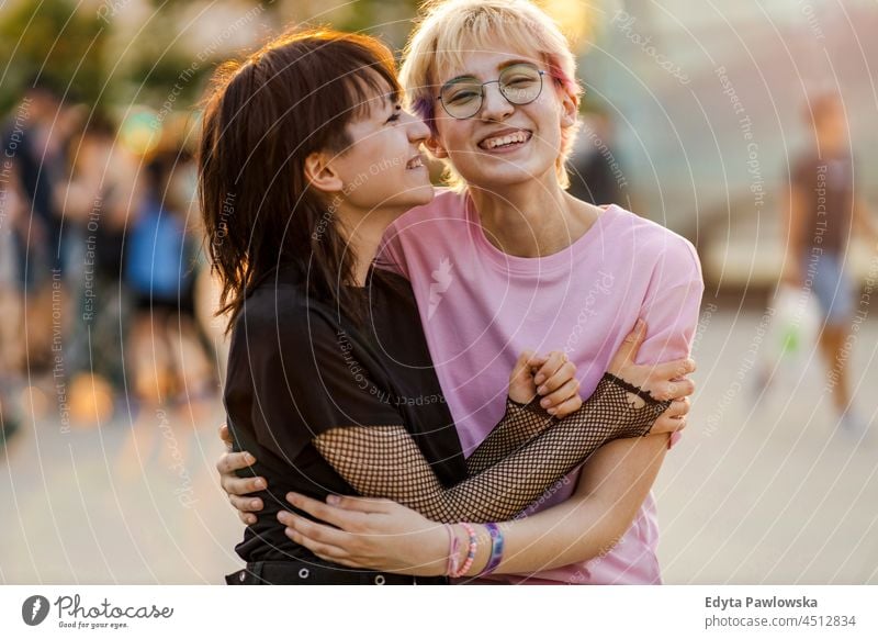 Young gender fluid couple hugging on city street homosexual couple love together romantic queer non-binary lgbt equality millennials gender-blend transgender