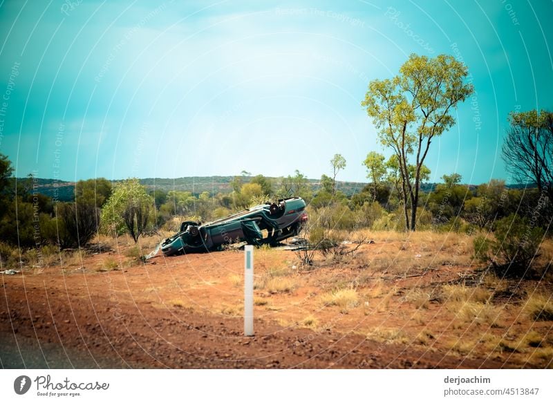 Serious accident in the outback. The car lies smashed on its roof on the side of the road. Accident Broken Deserted Colour photo Exterior shot Day Damage