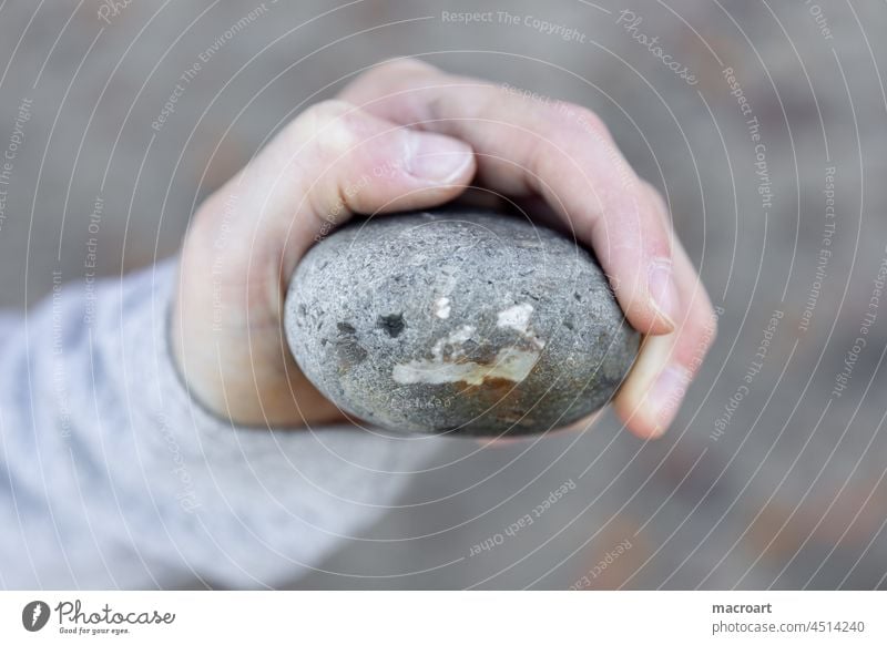 Child holding stone with face - pareidolia Face Stone Children`s hand stop Close-up macro detail Detail Hand Fingers Small Smiley smily