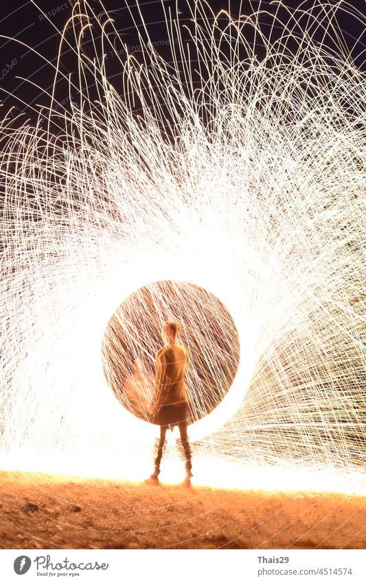 Iron wool circle drawing light fireworks. Burning Steel Wool spinning, Trajectories of burning sparks at night. Movement light effect, steel wool fire hoop. long exposure light painting, Pyrotechnic