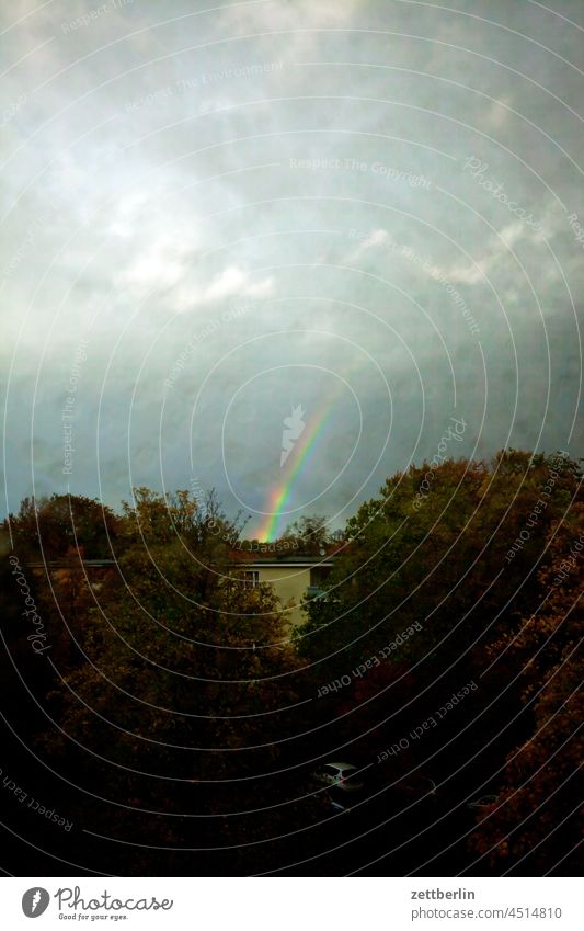 Lower part of a rainbow Evening altocumulus Menacing Dark Twilight somber colour spectrum Closing time Worm's-eye view Thunder and lightning cumulus cloud Sky