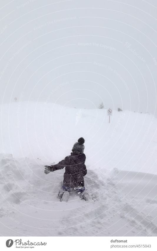 Child playing in snow on ski slope in fog weather Snow Deep snow Peak Winter Mountain Weather Snowcapped peak Alps Landscape Cold fun Freeze Christmas