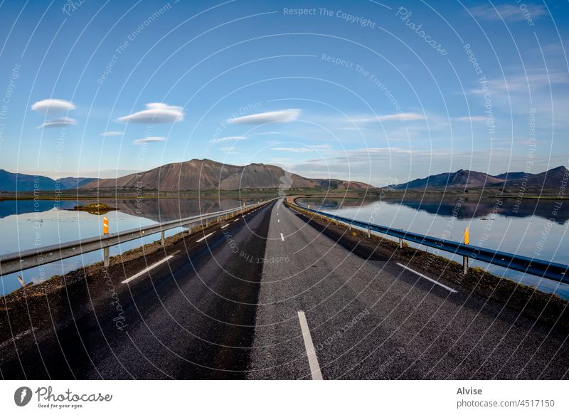 2021_08_10_snaefellsnes reflections between road and mountains water travel lake outdoor view scenic landscape nature rock iceland sky natural field grass