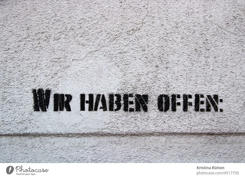 we have openly sprayed text on the wall Open Clue info Wall (building) Sprayed Stencil letters Graffiti writing Text opening hours Opening time Business Shop