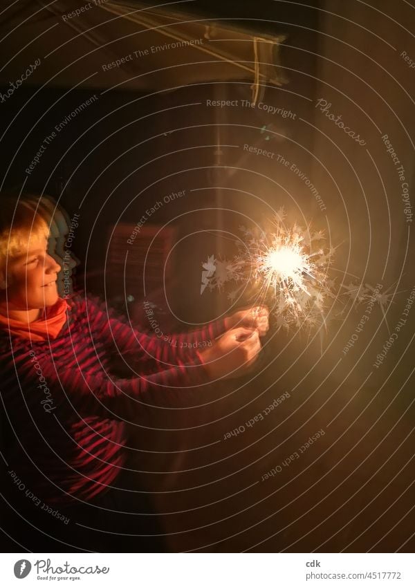 Childhood | Spark. Boy (child) Sparkler Night burn sparkler Observe look at To enjoy fun New Year's Eve Illuminate celebrations Light in the darkness lit Face