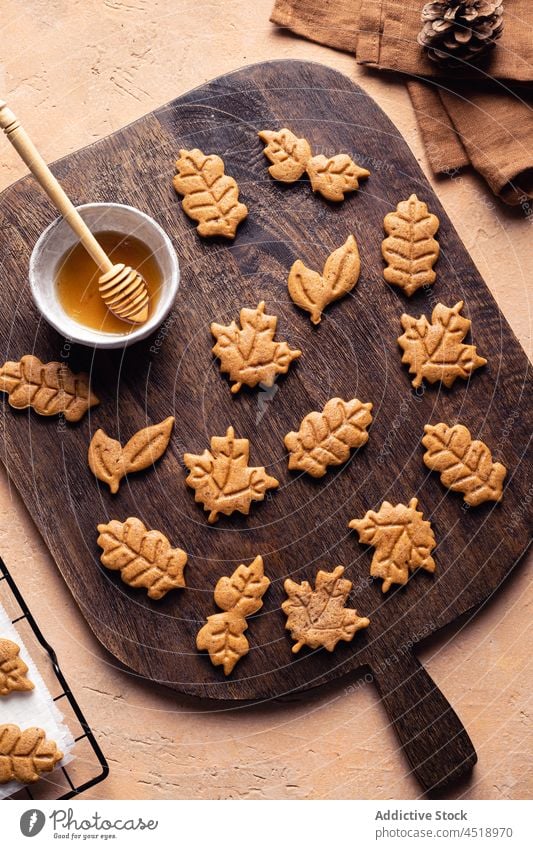 Leaf shaped cookies with honey dessert cutting board baked sweet homemade culinary pastry leaf autumn confection tasty table delicious yummy confectionery