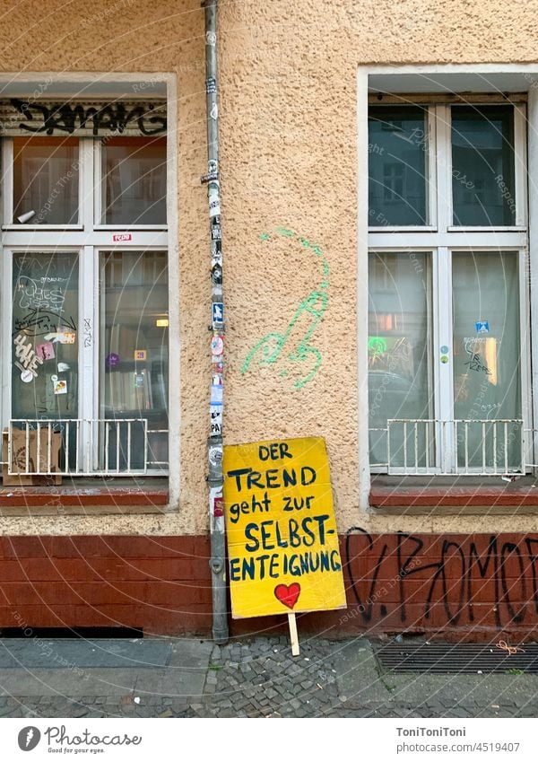 Transparent in front of a wall of houses on the subject of "housing Self-appropriation Demonstration Signs and labeling Banner Facade House front Glazed facade