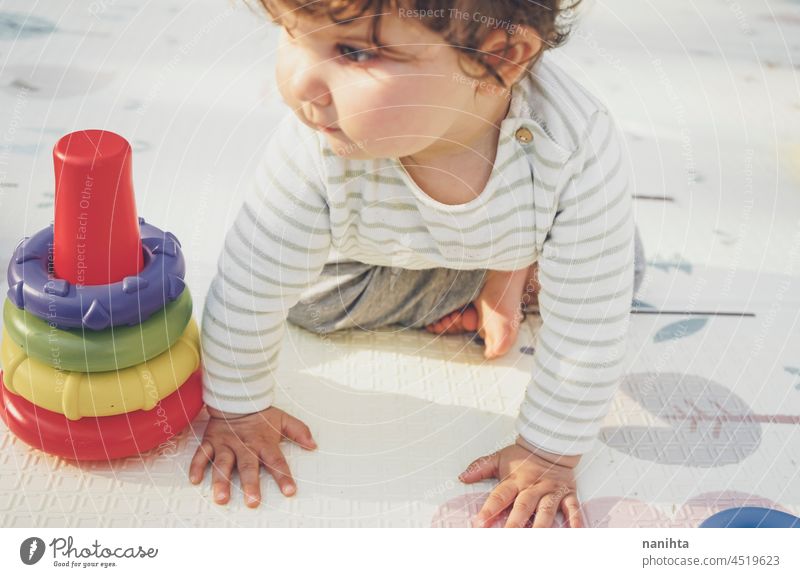 Little baby enjoying the day playing with her toys playful crawl crawling babyhood parenthood toddler happy happiness kindergarten outdoors nature natural