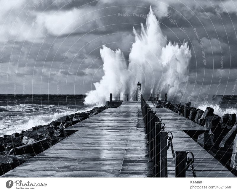 Black and white picture of the lighthouse on the pier of Nørre Vorupør during storm and high waves, Jutland, Denmark Lighthouse Gale Waves Weather Hurricane