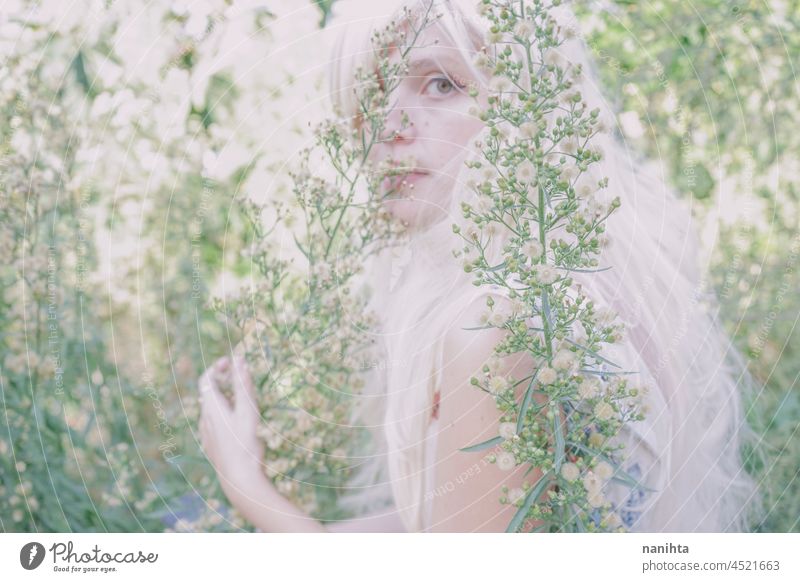 Artistic and reamy portrait of a woman surrouded by nature forest fantasy fairy delicate albino fairy tale feminine femininity long hair white caucasian pale