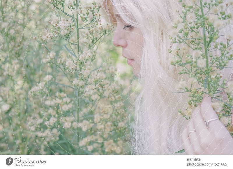 Artistic and reamy portrait of a woman surrouded by nature forest fantasy fairy delicate albino fairy tale feminine femininity long hair white caucasian pale