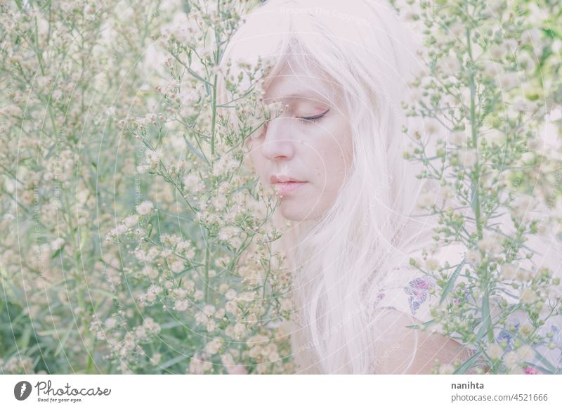 Artistic and reamy portrait of a woman surrouded by nature forest fantasy fairy delicate albino fairy tale feminine femininity long hair white caucasian pale