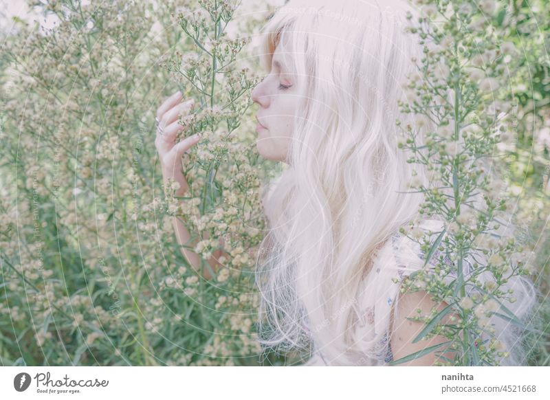 Artistic and reamy portrait of a woman surrouded by nature forest fantasy fairy delicate albino fairy tale feminine femininity long hair white caucasian pale