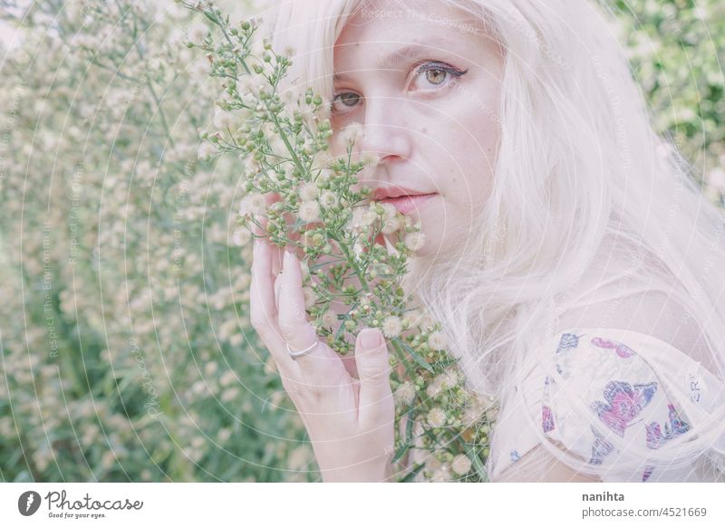 Artistic and reamy portrait of a woman surrouded by nature forest fantasy fairy delicate albino fairy tale feminine femininity long hair white caucasian pale