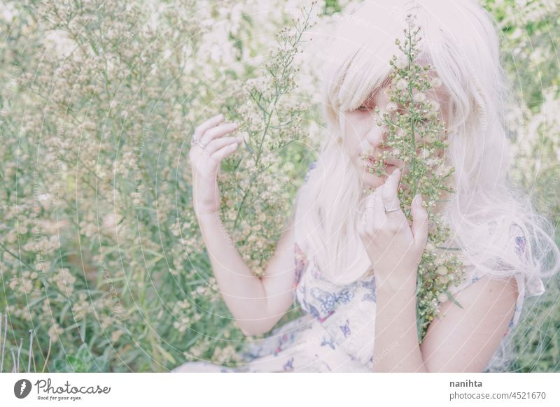 Artistic and reamy portrait of a woman surrouded by nature forest fantasy fairy delicate albino fairy tale feminine femininity long hair white caucasian pale