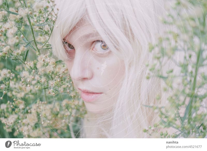 Artistic and reamy portrait of a woman surrouded by nature forest fantasy fairy delicate albino fairy tale feminine femininity long hair white caucasian pale