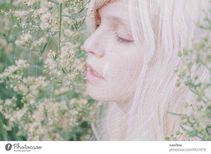 Artistic and reamy portrait of a woman surrouded by nature forest fantasy fairy delicate albino fairy tale feminine femininity long hair white caucasian pale