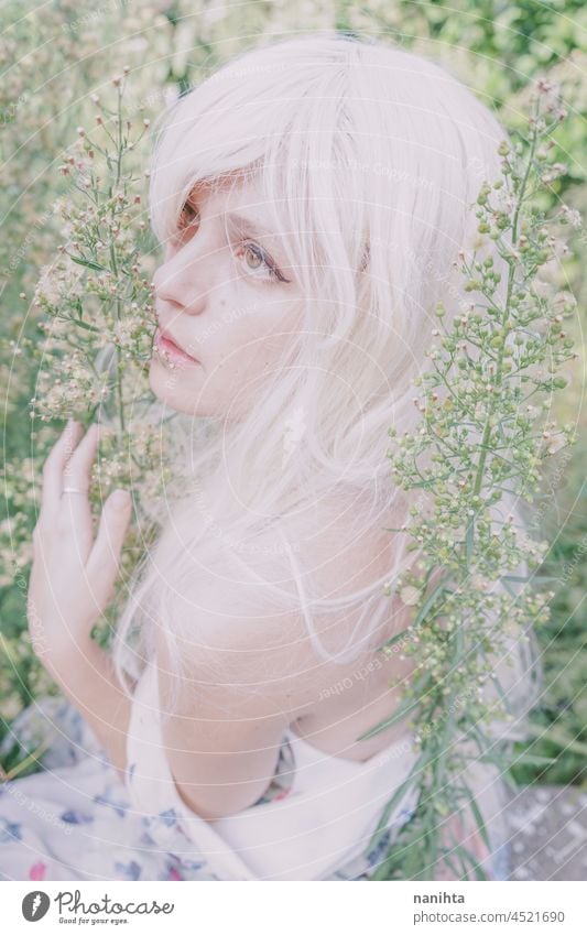 Artistic and reamy portrait of a woman surrouded by nature forest fantasy fairy delicate albino fairy tale feminine femininity long hair white caucasian pale