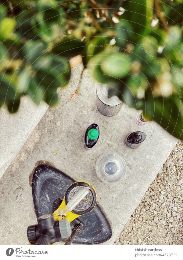 Bicycle repair on Sufen in front of the villa, Feltre, South Tyrol, Italy Air pump Oil can oil bottle maintenance Repair Wheel repair Stage Concrete bush Plant