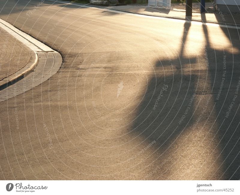 Street with evening sun Evening sun Signs and labeling Tar Light Transport Shadow Curve