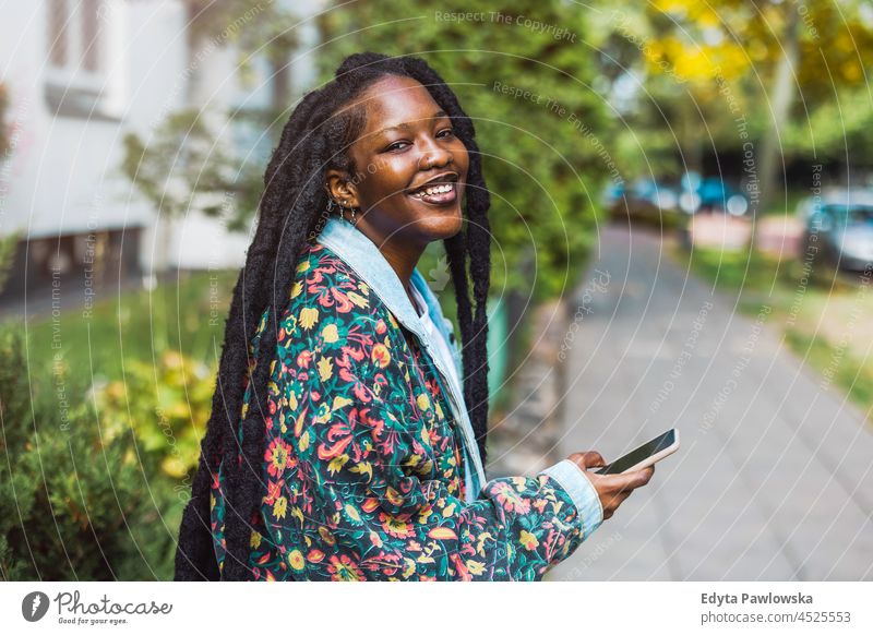 Attractive young woman using her smartphone outdoors unaltered natural real people authentic body inclusivity body positive one person hipster girl hairstyle